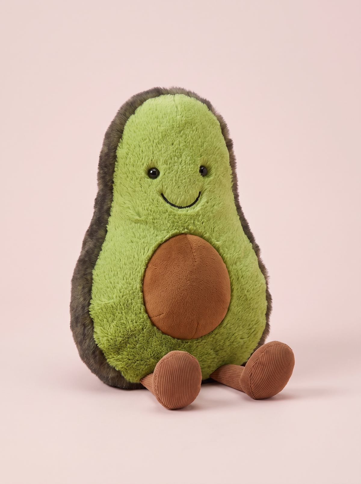 Avocado Plush Toy front view on a pink studio background