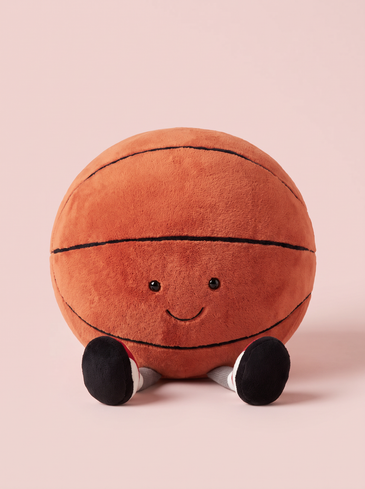 Basketball Plush Toy front view on a pink studio background