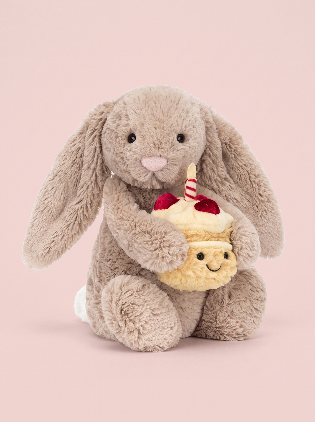 Birthday Cake Bunny Plush Toy front view on a pink studio background
