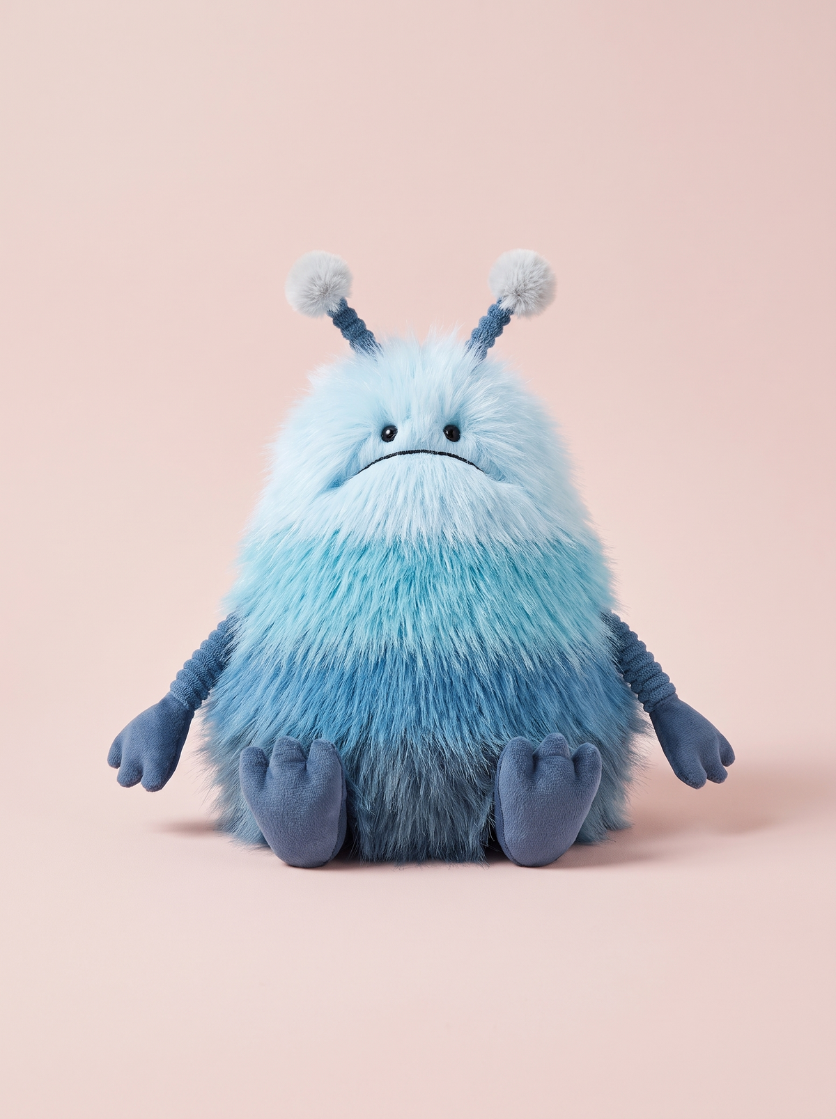 Blue Alien Plush Toy front view on a pink studio background