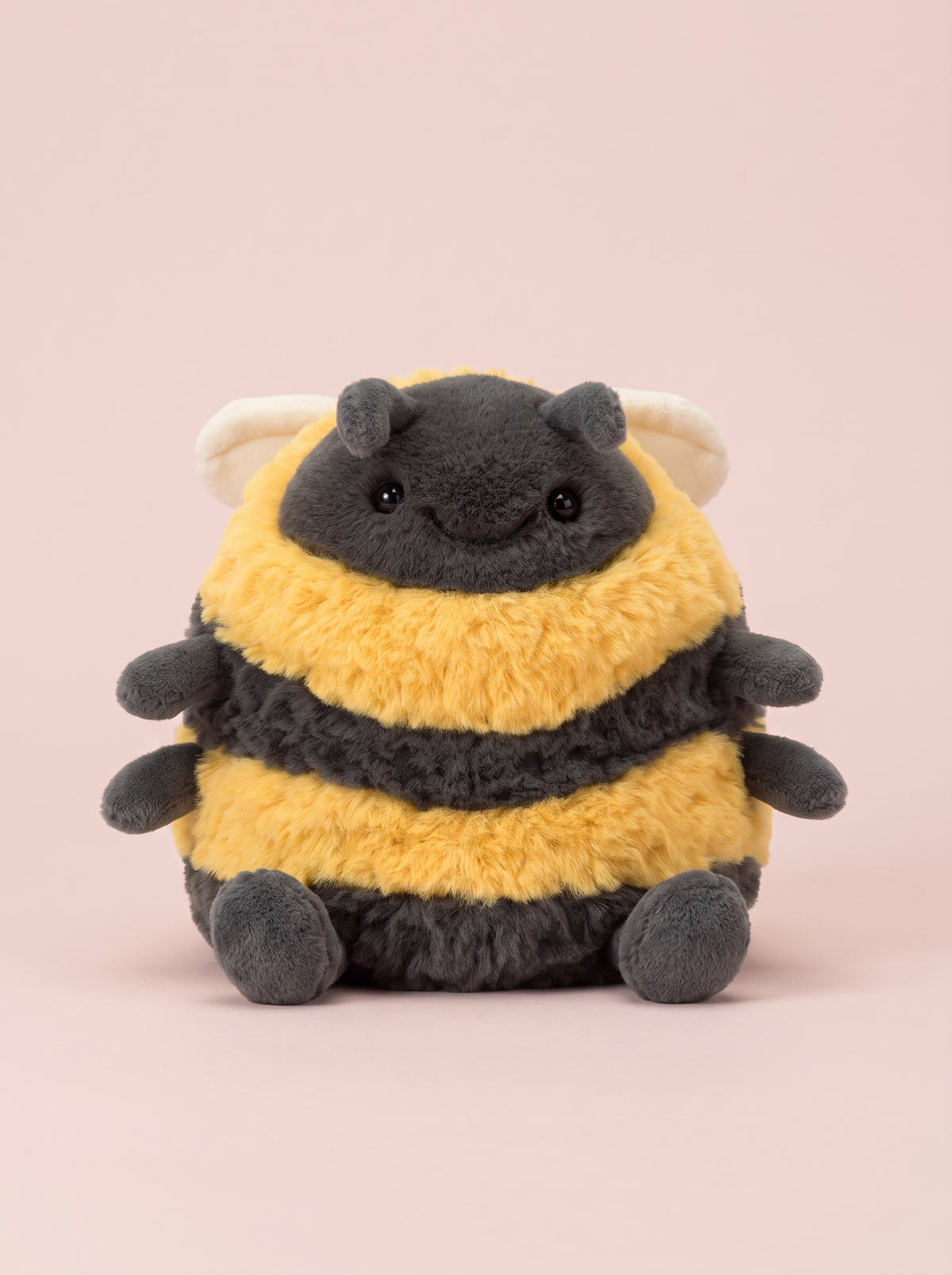 Bumblebee Plush Toy front view on a pink studio background