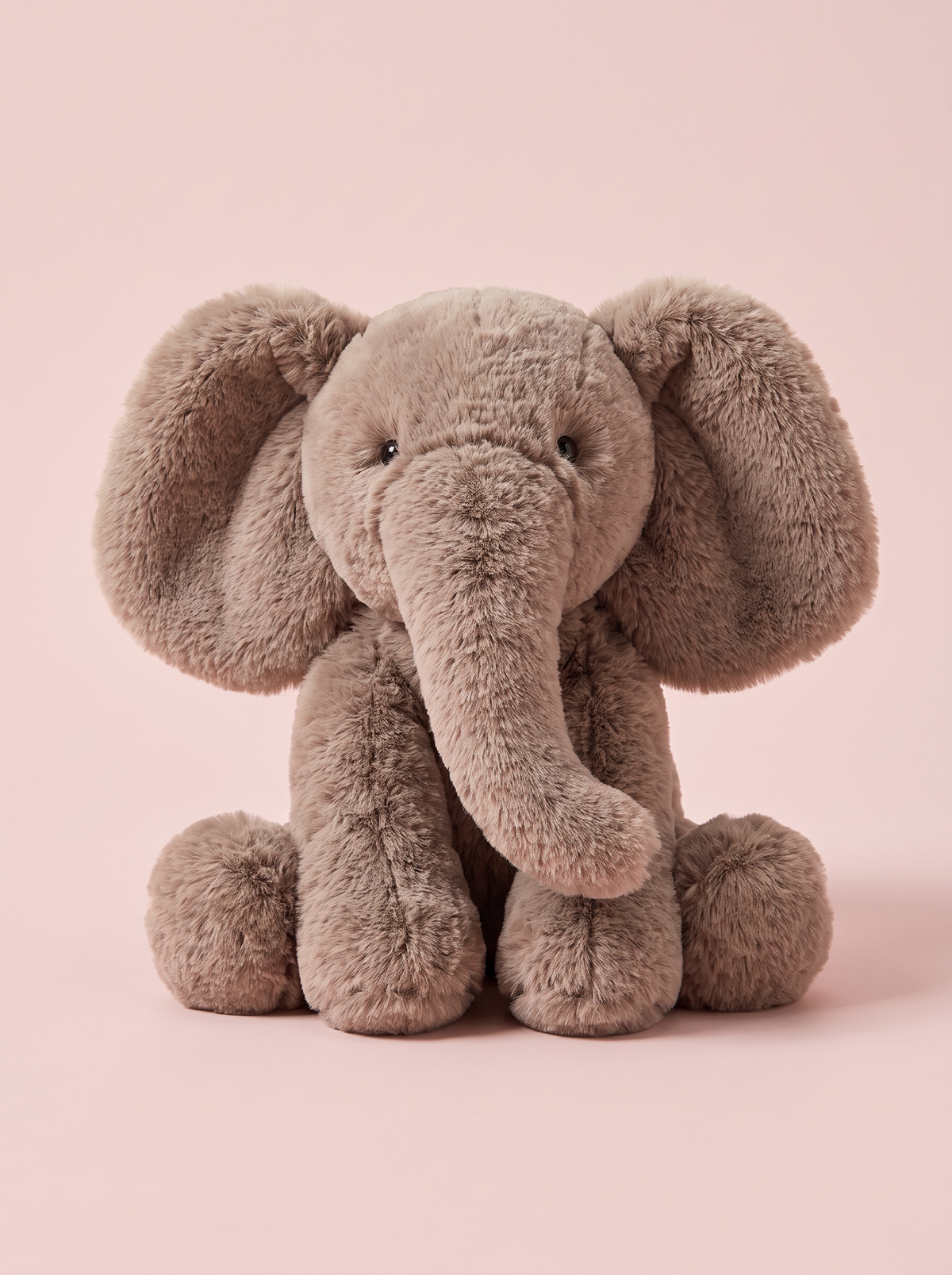 Elephant Plush Toy front view on a pink studio background