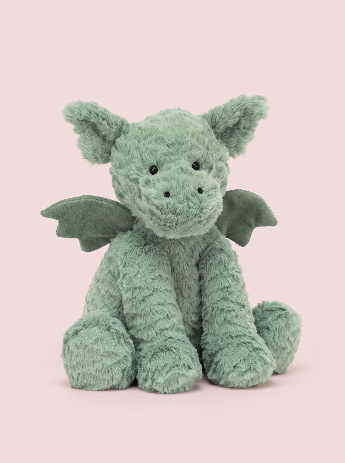 Fluffy Green Dragon Plush Toy front view on a pink studio background