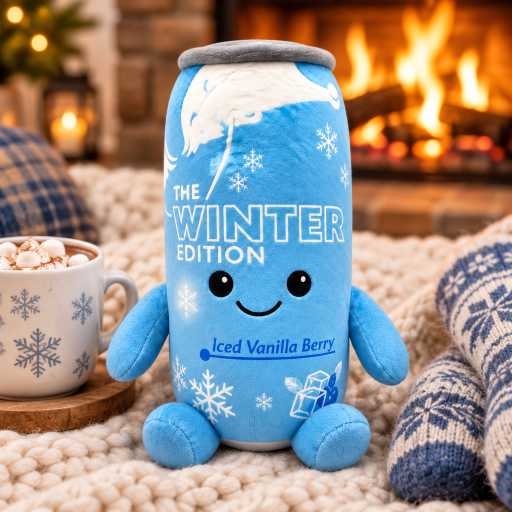 Red Bull Winter Edition plush toy by a cosy fireplace