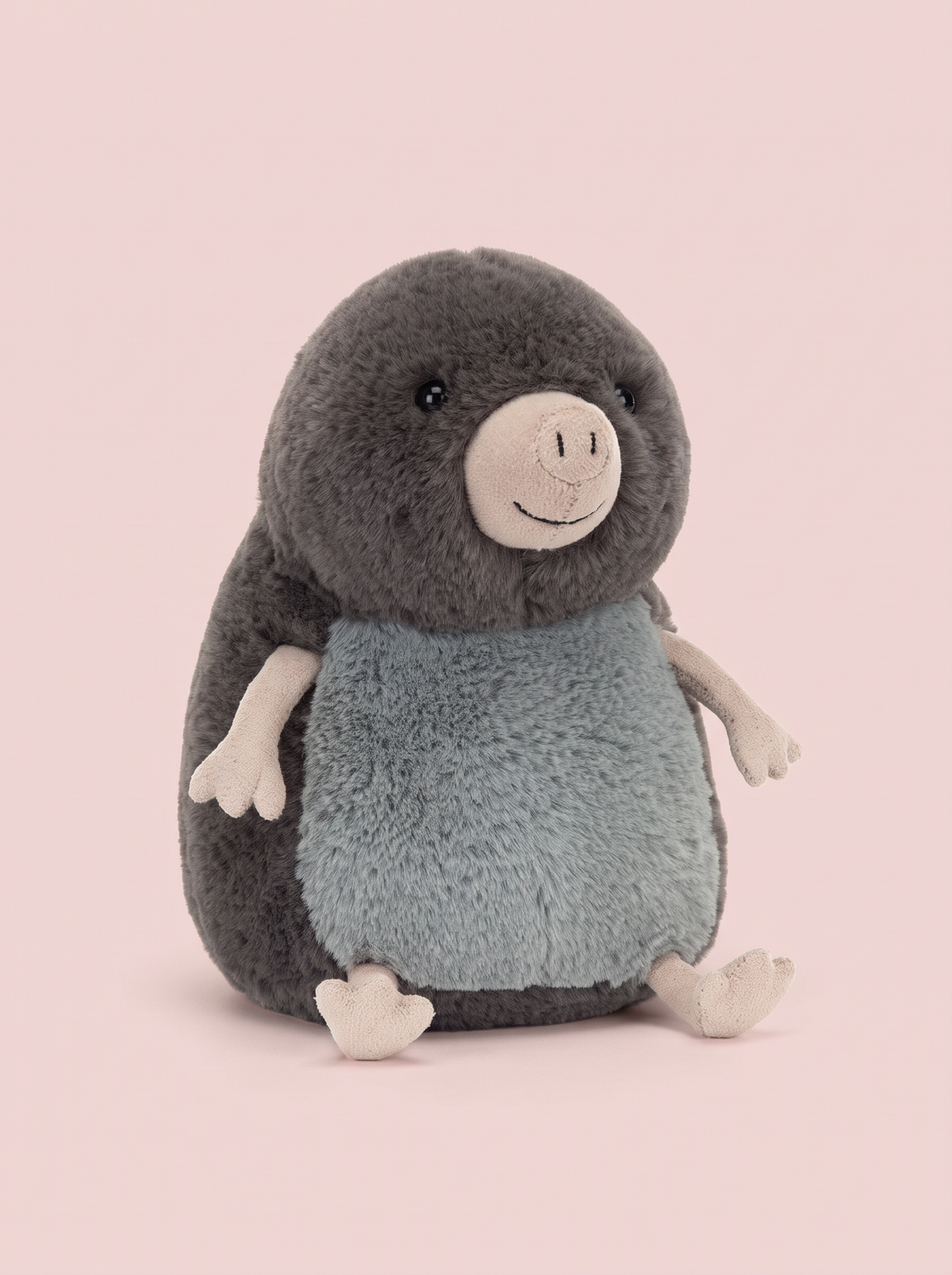 Mole Plush Toy front view on a pink studio background