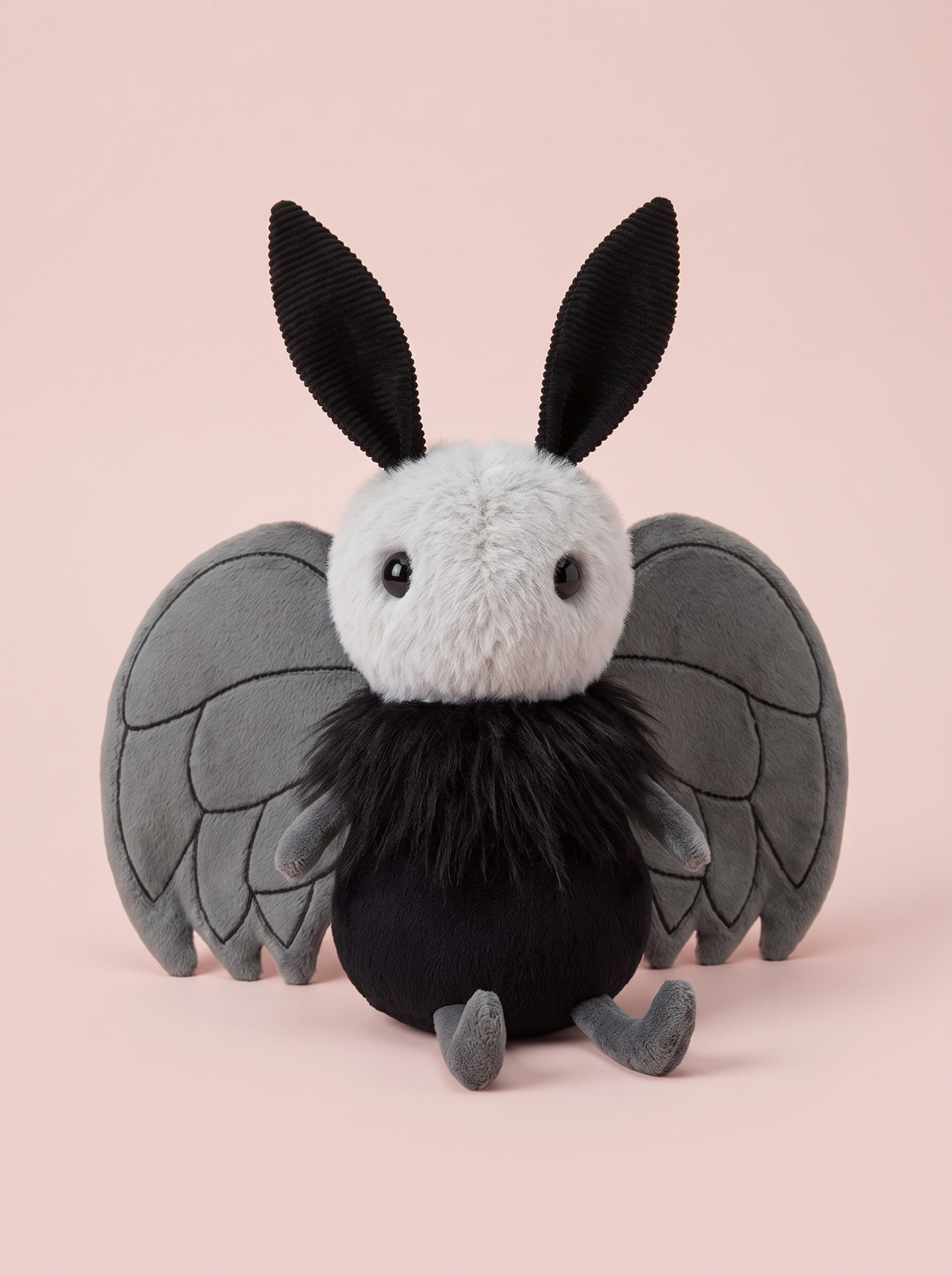 Moth Plush Toy front view on a pink studio background