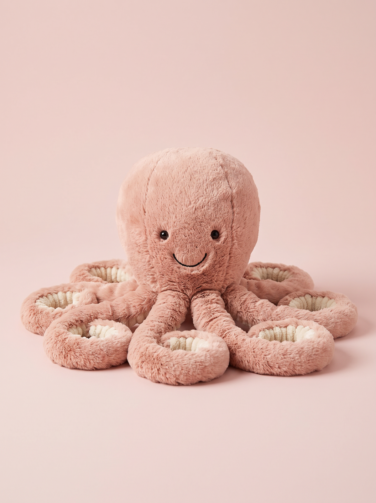 Octopus Plush Toy front view on a pink studio background