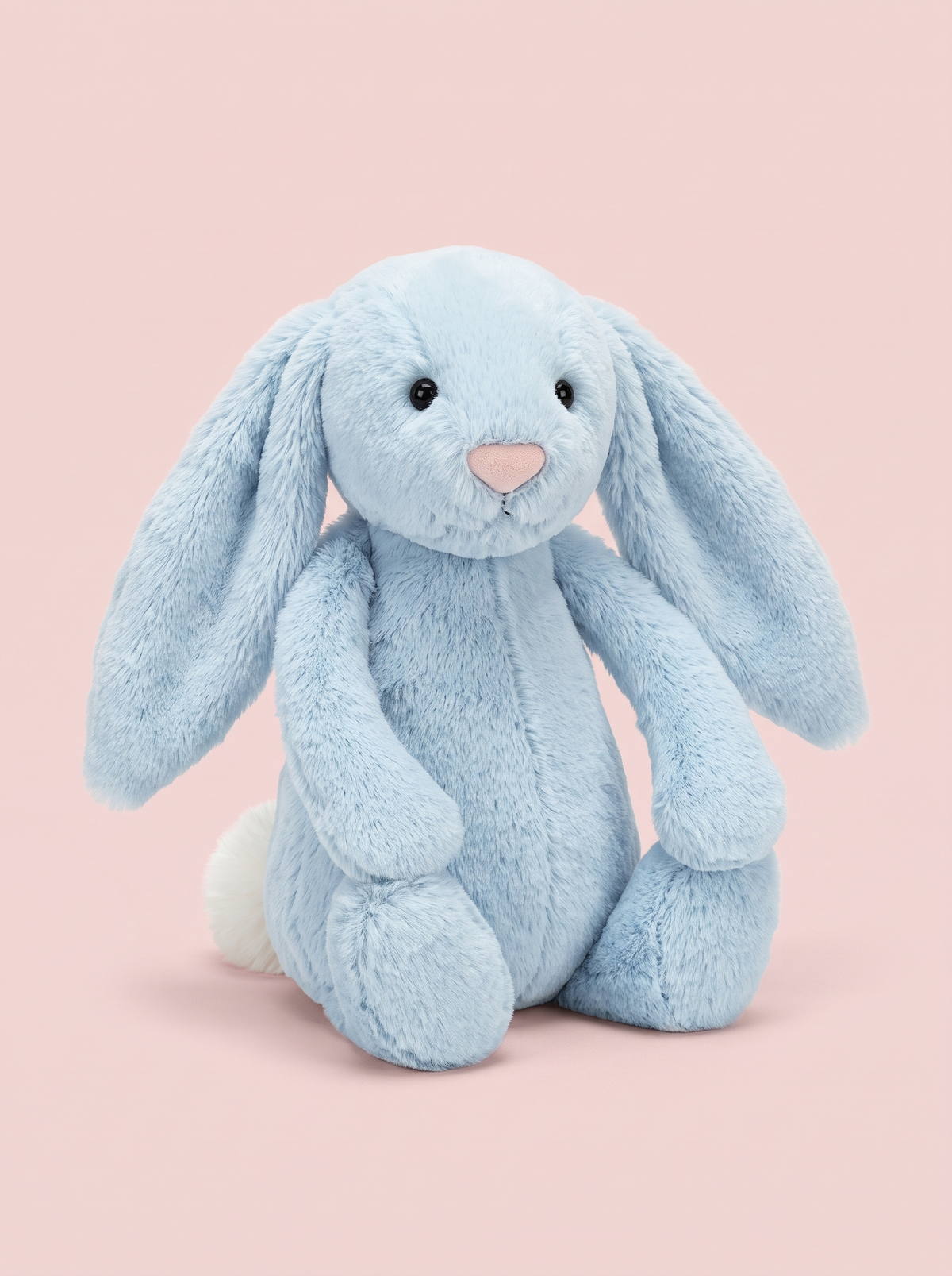 Pale Blue Bunny Plush Toy front view on a pink studio background