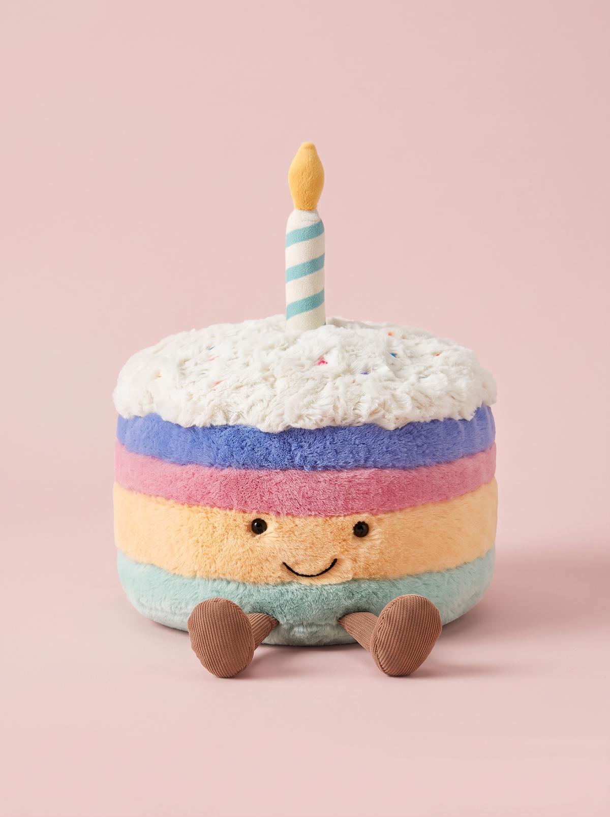 Rainbow Birthday Cake Plush Toy front view on a pink studio background
