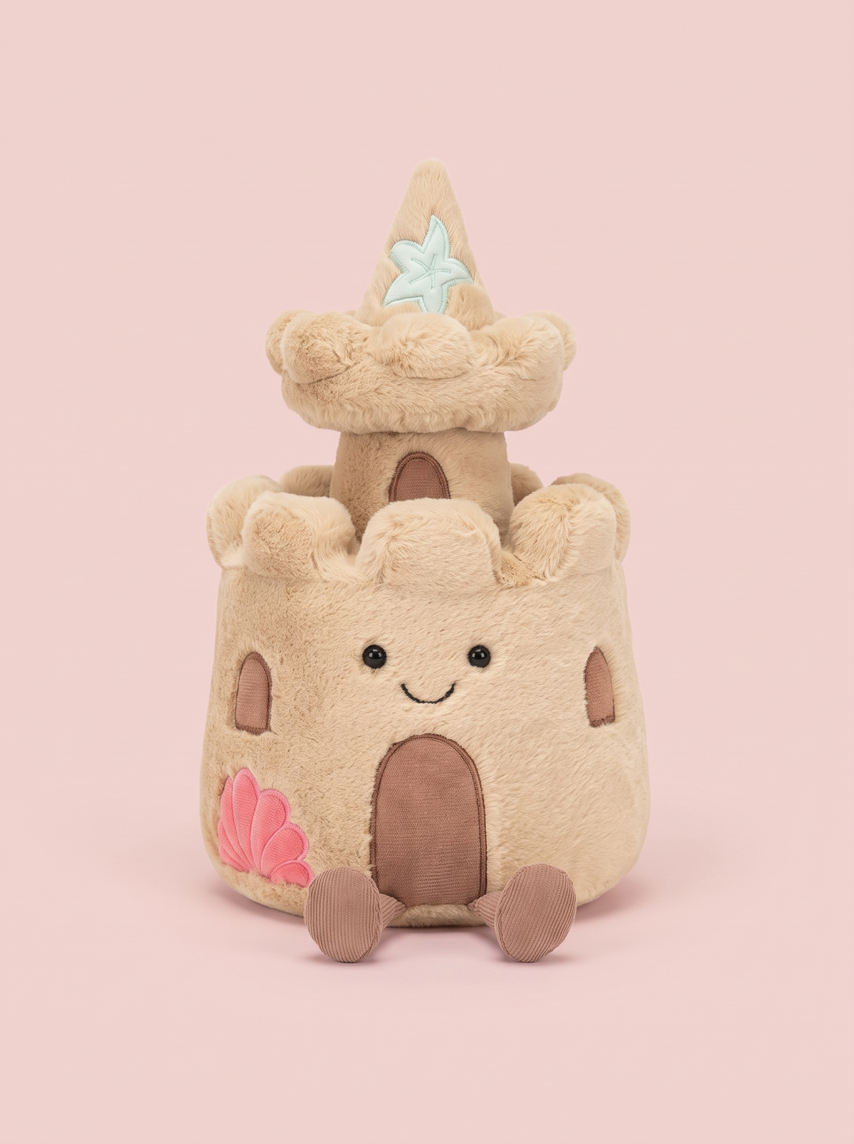 Sandcastle Plush Toy front view on a pink studio background