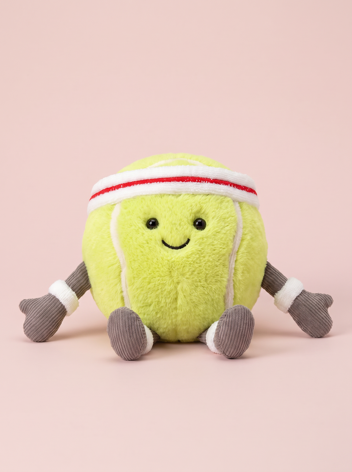 Tennis Ball Plush Toy front view on a pink studio background