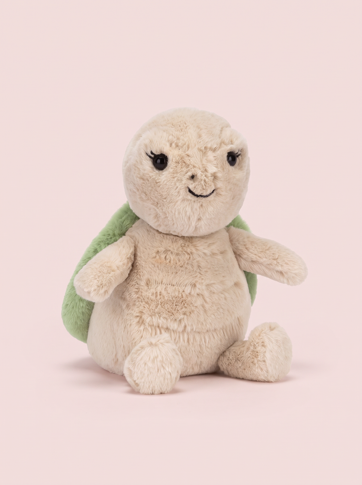 Turtle Plush Toy front view on a pink studio background