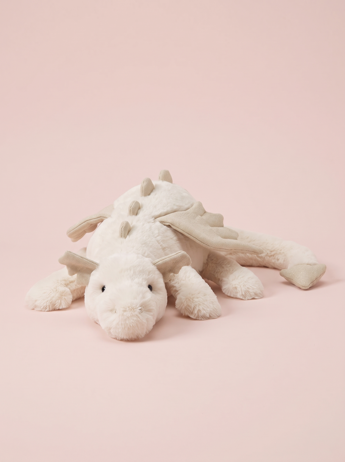 White Dragon Plush Toy front view on a pink studio background